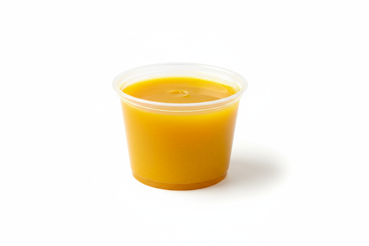 2 oz condiment container with turmeric juice in it 